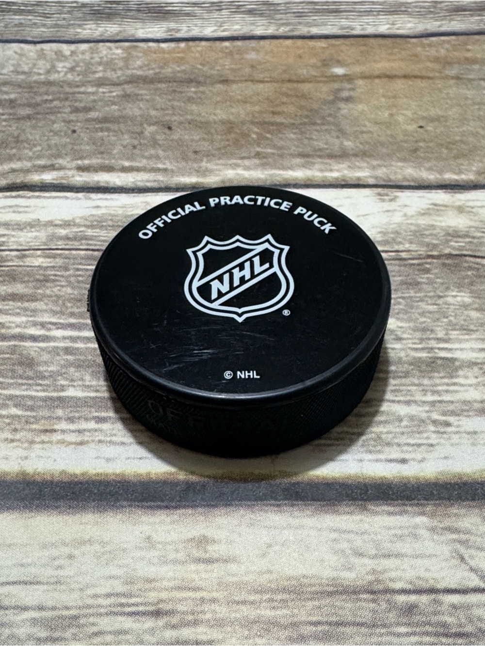 Detroit Red Wings Used NHL Black Practice Hockey Puck with White Logo Shield